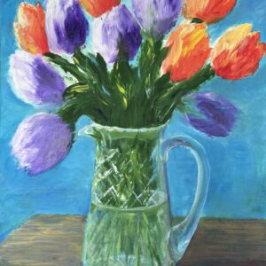 Orange and Purple tulips in a glass vase.